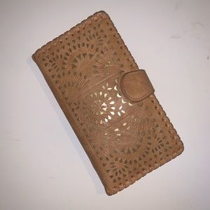 Madison West travel wallet with gold accents